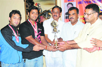 Arun Singh (second from left), along with another shooter, being felicitated in Dehradun