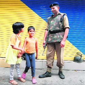 Two kids find a friend during a bandh in Srinagar