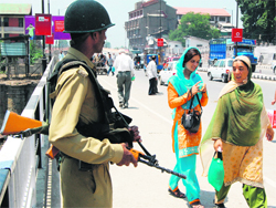 A security jawan stands guard at Bud Shah Chowk in Srinagar as normal life resumes in the Valley 