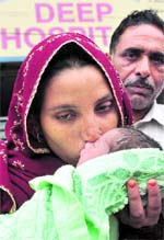 Rukkayia kisses her child, who was recovered from the kidnappers on Monday night