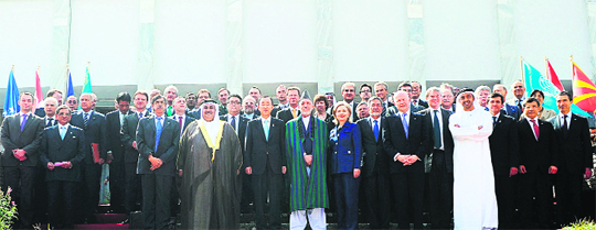 Afghan President Hamid Karzai poses with United Nations Secretary General Ban Ki-moon to his right and US Secretary of State Hillary Clinton to his left as they and other international representatives pose for a group photo at the conclusion of the International Conference on Afghanistan, in Kabul 