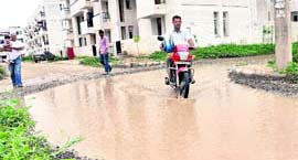 a motorcyclist makes his way through the accumulated rainwater at Sector 49 in Chandigarh on Wednesday.