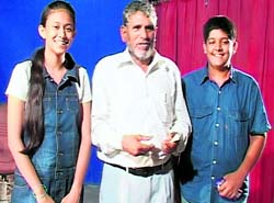 Minister of State for Food and Supplies Diwakar Bhatt with the two young skaters 