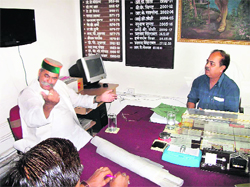 Mussoorie MLA Jot Singh Gunsola argues on an issue in front of Executive Officer RP Semwal at the Nagar Palika Office in Mussoorie