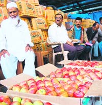 Farmers selling their apples in local mandi Dhalli, near Shimla, on Wednesday.