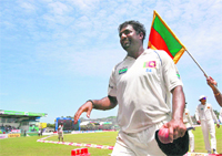 Muttiah Muralitharan walks back to the pavilion after the end of India's first innings during the fourth day of their first Test in Galle