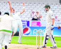 Pakistan's Umar Gul celebrates after taking the wicket of Australia's Michael Hussey during the first day of the second Test at Headingley, in Leeds 