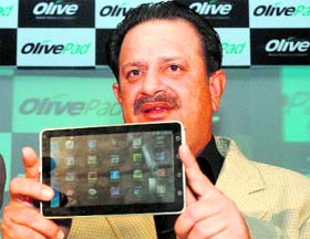 Olive Telecommunications India chairman Arun Khanna displays the 3G tablet Olive pad at its launch in New Delhi on Thursday.