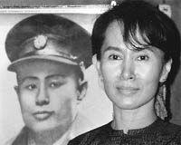 Aung San Suu Kyi stands before her fathers portrait