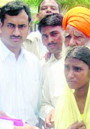  The DC, CG Rajini Kaanthan, hands over cheques for the wedding of a girl at Balasar, Sirsa.