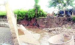 The foundation of a wall damaged by a seasonal rivulet at Shivalik Nagar in Haridwar. 