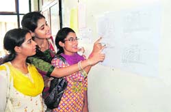 Candidates search their names in the second merit list at University of Jammu on Friday.