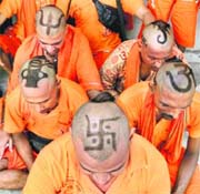 Amarnath pilgrims show their special haircut resembling religious symbols at the Aggarwal Sabha in Jammu on Friday. 