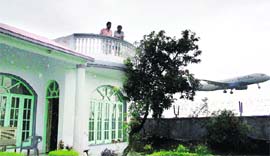 A house adjacent to the boundary wall of the Jammu airport.