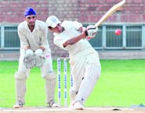 A player of DP Azad Green team plays a shot during a match at St Stephens in Chandigarh on Saturday.