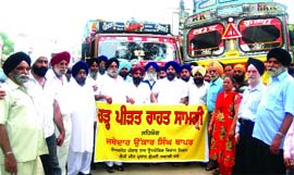 Vice-president of the Shiromani Akali Dal (Badal) and chairman of the Punjab State Industrial Development Corporation Onkar Singh Thaper with residents send two trucks loaded with relief material for flood-affected areas in Punjab, in New Delhi on Saturday