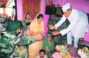 Amarnath pilgrims and Army personnel take part in a havan at Mata Jawalaji temple at Khrew near Pampore in Pulwama district on Saturday.