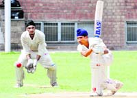 A player of DP Azad Red team plays a shot during a match at St Stephens in Chandigarh on Sunday.