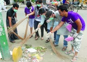 Volunteers of a cleaning campaign launched by The Art of Living, an NGO, sweep an area in Dilshad Garden