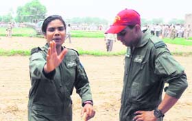 Flt Lt Arunima requests villagers to keep distance as her colleague Haseer Hamid stands distraught after the landing