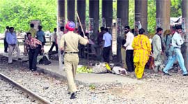 A policeman charges at protesting BEd teacher aspirants near the Ferozepur railway line in Ludhiana on Sunday.