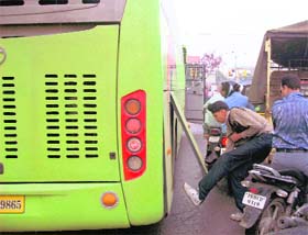 A driver halts his bus to fix a fault at the Bharat Nagar Chowk in Ludhiana.