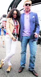 Boris Becker (R) and his wife Lilly pose for photographers before the race of the German F1 Grand Prix at Hockenheimring in Hockenheim, on Sunday