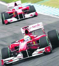 Ferraris Fernando Alonso drives ahead of teammate Felipe Massa in the German GP, on Sunday