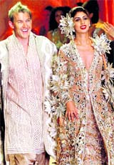 Australian cricketer Brett Lee and socialite Shweta Nanda walk the ramp at the Pearls Infrastructure Delhi Couture Week 2010 in New Delhi late on Sunday.