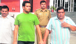 Rakesh Goel (right) and his son Vikas Goel in custody at the Economic Offen