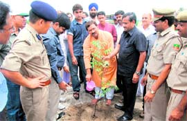 Agriculture Minister Trivendra Singh Rawat plants a sapling as part of the Harit Vikas Yojana at Bishanpur Block in Haridwar on Monday.