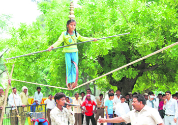 A girl shows her skills on a rope near the bus stand in Karnal.