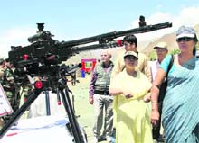 Family members of Kargil martyrs look at arms near the war memorial after the wreath-laying ceremony in Drass on Monday