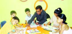 Children make drawings during a summer camp at Young Wonder School in Amritsar