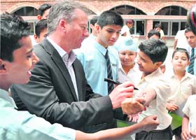 Former Australia captain signs an autograph on the arm of a student at St Stephen’s School, Sector 45, in Chandigarh