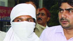 Shahid Khan in police custody in New Delhi on Tuesday.