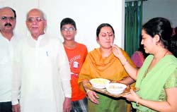 The family of Vishwajeet Singh celebrates after he was rescued by the police after being kidnapped in Nainital on Tuesday