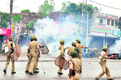 Cops lob tear gas shells to disperse protesters on the Jammu-Pathankot National Highway in Samba