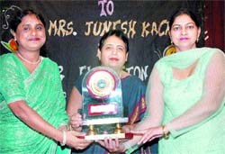 Principal of the Hans Raj Mahila Maha Vidyalaya, J Kackria, being honoured in the college in Jalandhar