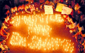 Students of Panjab University light candles at Student Centre in Chandigarh on Wednesday