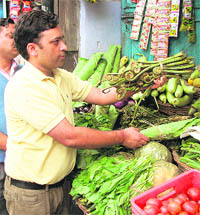 A consumer buys fiddlehead fern at a vegetable shop in Mussoorie.