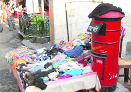 A post box being used to sell clothes at a street in Nainital.
