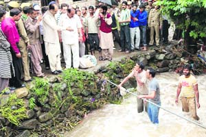 Minister of State for PHE and Tourism Nasir Aslam Wani visits a village hit by flash floods in Bandipore district on Wednesday.