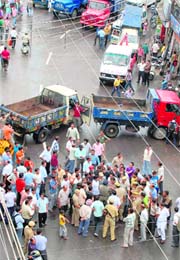 MC vehicles block the road in Kachhi Chawni Chowk after a clash between policemen and MC officials in Jammu on Wednesday.