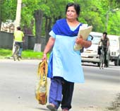 Postwoman Nirmala Devi on her way to work.