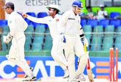 Sri Lankan players celebrate the wicket of Virender Sehwag on Wednesday. 