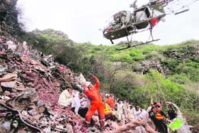 A helicopter picks bodies from the site of plane crash in Islamabad