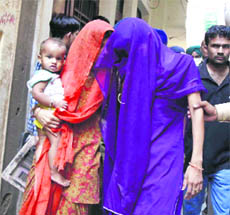 Policemen escort Mohini and her relatives at Mani Majra on Thursday.