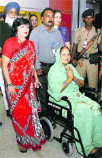 Surinder Kaur Badal (in wheel chair) returned to India on Wednesday night after treatment at a US hospital. On her arrival, she was received, among others, by her husband and Punjab Chief Minister Parkash Singh Badal (seen in the picture) at Indira Gandhi International Airport in New Delhi. 