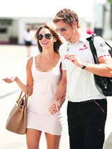 McLaren Formula One driver Jenson Button of Britain arrives with his girlfriend Jesica Michibata to the Hungaroring circuit near Budapest on Thursday, ahead of the Hungarian F1 Grand Prix.